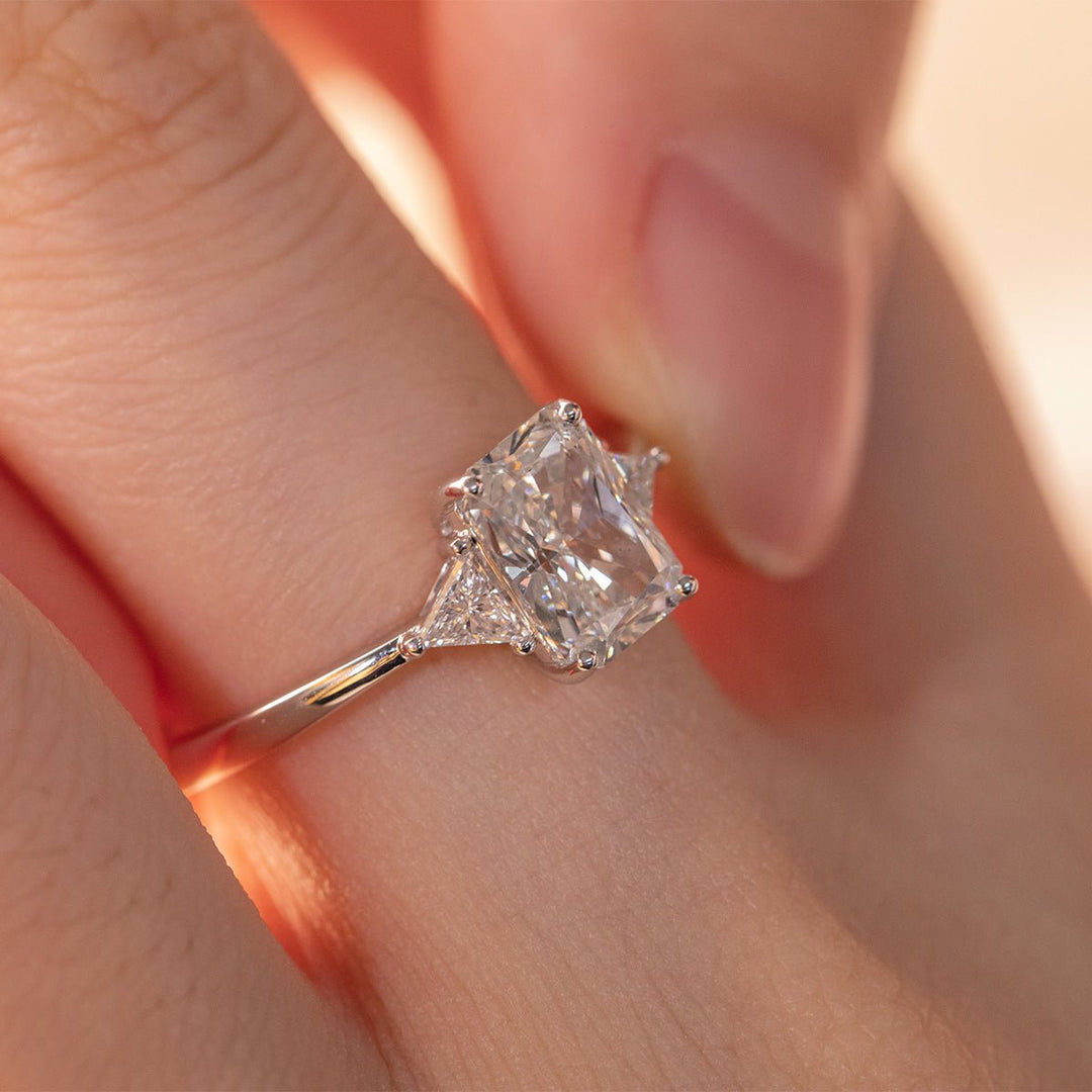 14K White Gold 1.5ct Radiant Cut Lab Diamond Three Stone Ring with Triangular Cut Lab Diamond Side Stones and Tapered Band Design - FIORESE JEWELRY