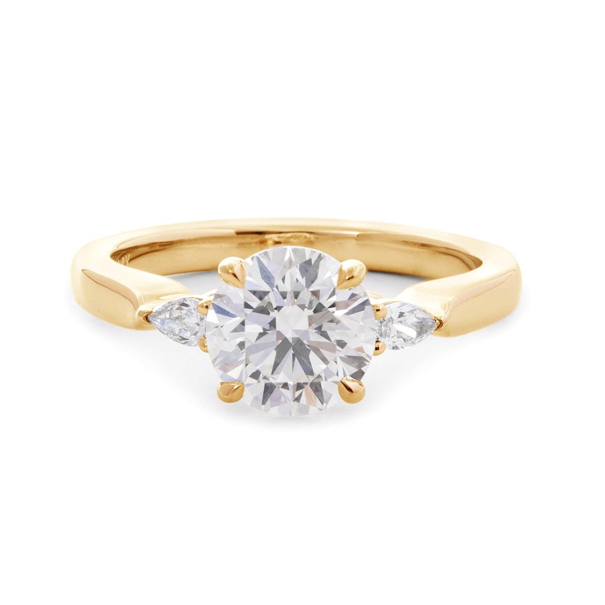 Round-Cut Lab Diamond Three-Stone Engagement Ring with Pear Side Stones and Cathedral Setting